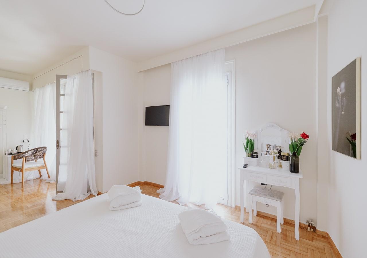 White room with a vanity table and sheer curtains